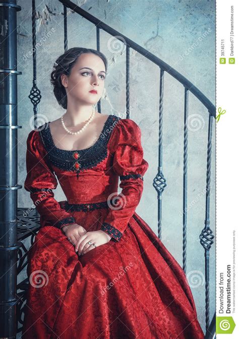 Beautiful Woman In Medieval Dress On The Stairway Stock