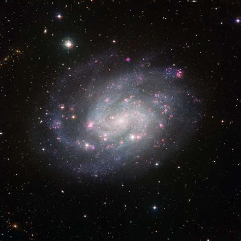 Suburban Spaceman Spiral Galaxy Like Our Own Shines With Pink Clouds