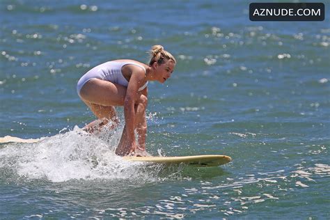 Margot Robbie Sexy In A White One Piece Swimsuit Surfing
