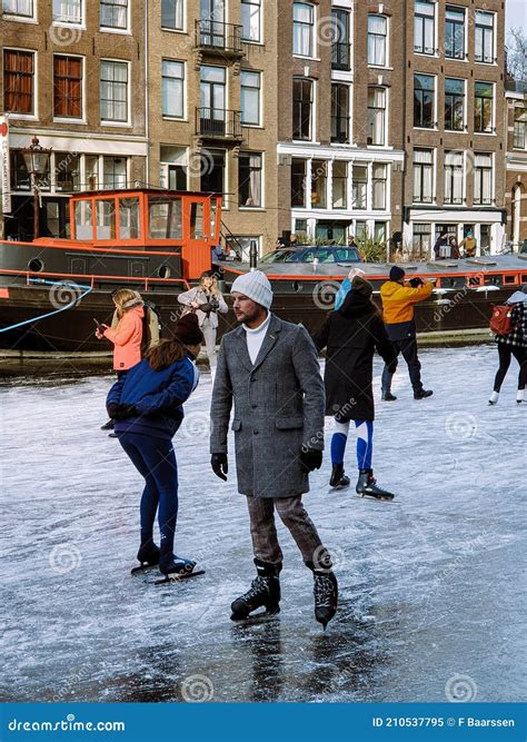 amsterdam netherlands frozen canals and people ice skating in amsterdam editorial image image