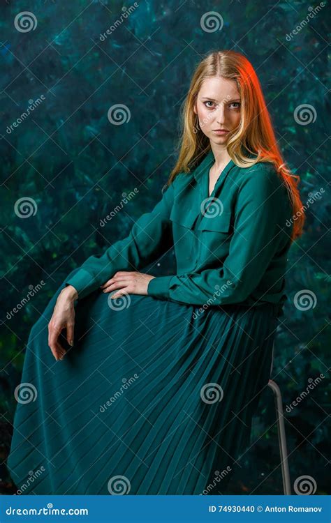 Blonde Girl On A Green Background In A Long Green Dress Stock Photo