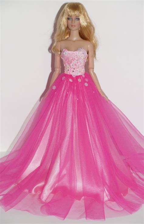 A Barbie Doll Wearing A Pink Dress With Flowers On The Bouncy Tulle