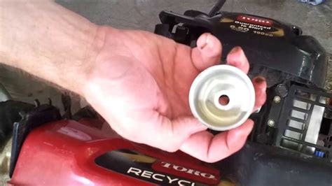 After removing a lawn mower's fuel tank to access the carburetor, the carburetor can be cleaned with a carburetor cleaner or a simple brush. Clean out Toro lawnmower carburetor jet - YouTube