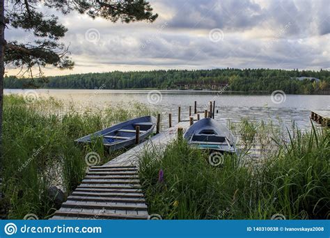 Old Boat Dock On A Lake On A Cloudy Morning On A Lake Stock Photo