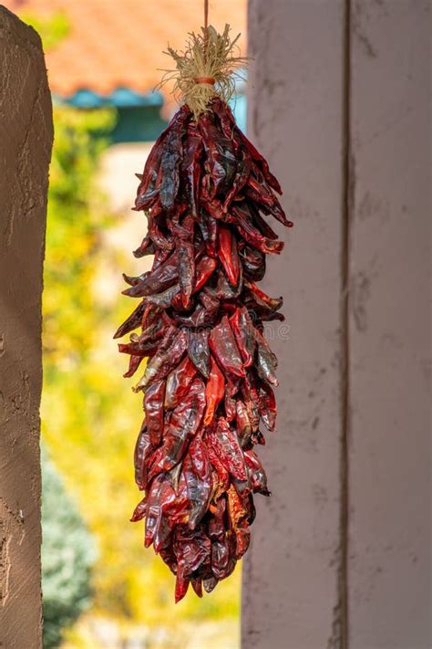 Hanging Chile Peppers On The Outside Of House As Both A Decoration And