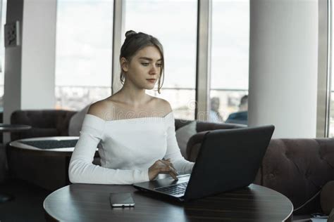 Young Business Woman Using Laptop Computer In Cafe Or In Coworking