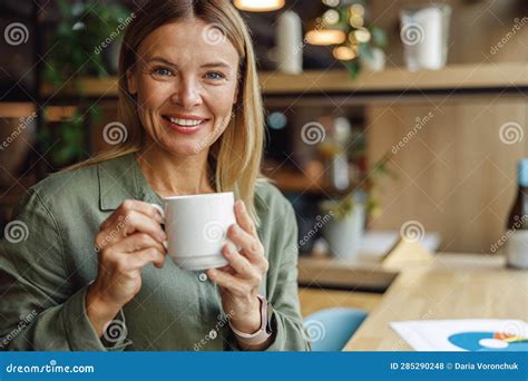 Attractive Business Woman Smiling And Looking At Camera While Drinking