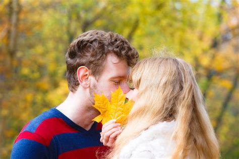 couple with maple leaf kissing in autumn park stock image image of sunny outdoor 76307585