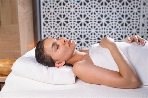 Young Asian Female With Closed Eyes Resting On The Massage Table Stock