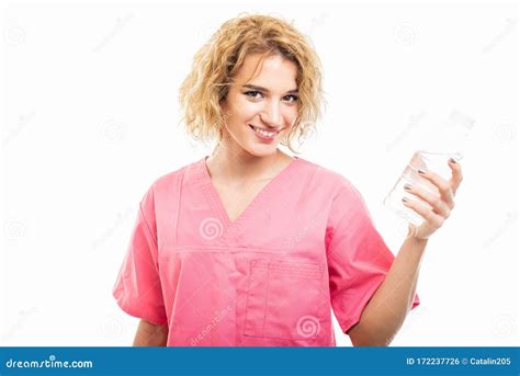 Portrait Of Nurse Wearing Pink Scrub Holding Bottle Of Water Stock