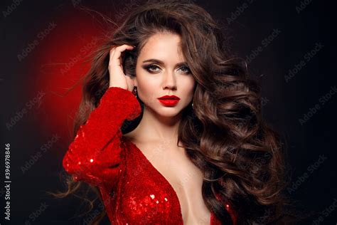 Beautiful Sexy Brunette In Red Dress With Healthy Curly Hair And Glamour Makeup Fashion Beauty