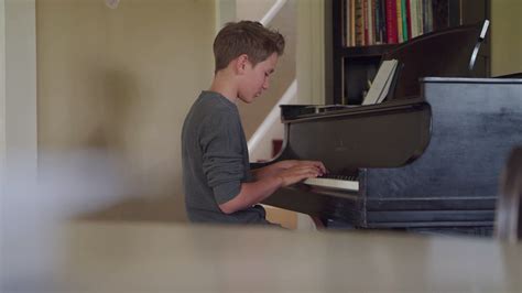 Young Boy Practicing The Piano Filmpac