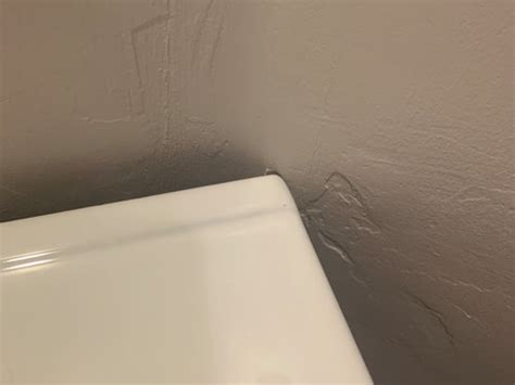 Could i trim out the drywall where it bulges out until the left and right side touch flush? HELP! Issue with vanity not being flush against wall