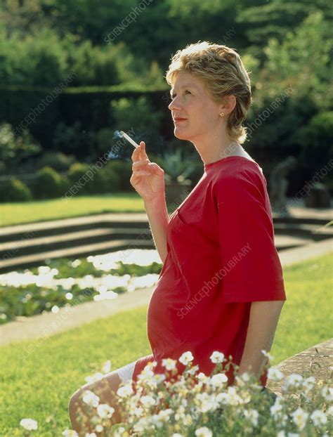 Pregnant Woman Smoking A Cigarette Outdoors Stock Image M805 0374 Science Photo Library