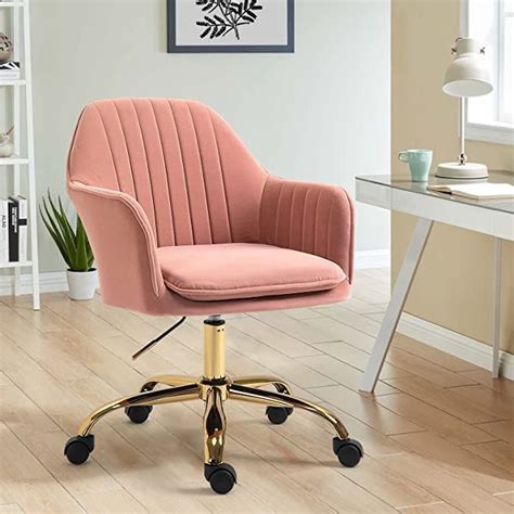 a pink office chair sitting on top of a wooden floor next to a white desk