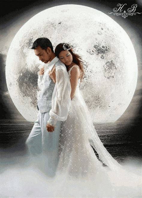 A Man And Woman Standing In Front Of A Full Moon
