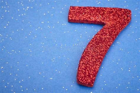 Number Seven Red Color Over A Blue Background Anniversary Stock Photo