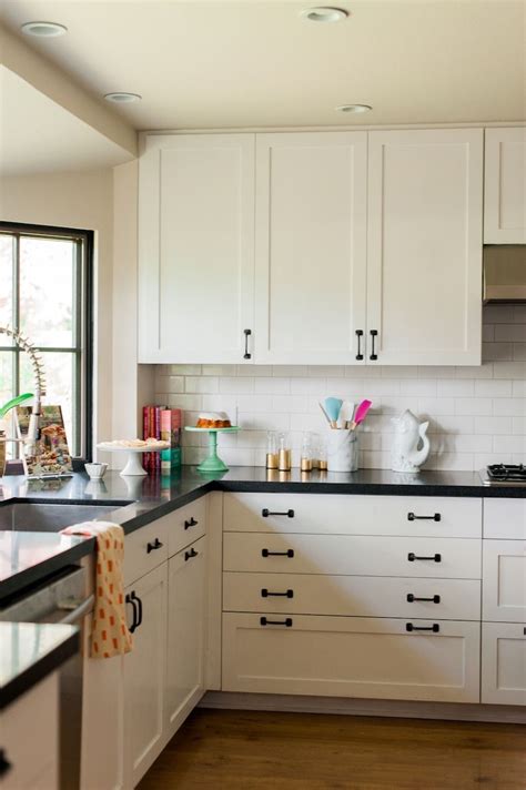 Antique white kitchen cabinets with black granite countertops. Caitlin Wilson Home Tour | Black countertops, Kitchen ...