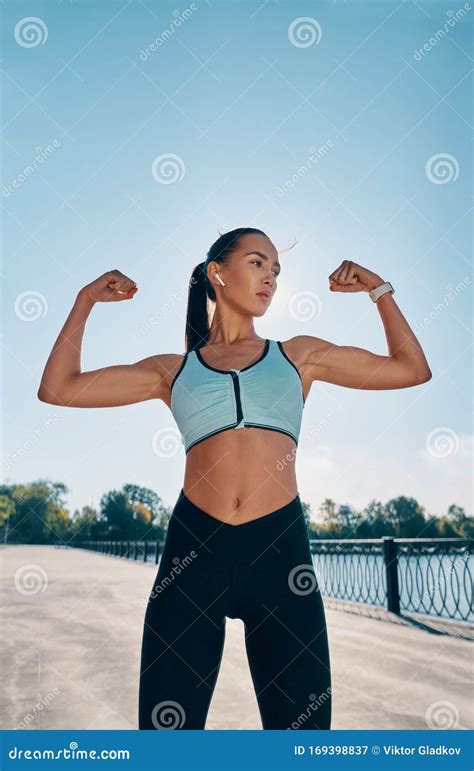 strong and confident beautiful woman flexing her muscles stock image image of exercise