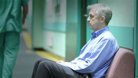 Time Lapse A Worried Man Sits Alone With His Thoughts In A Hospital