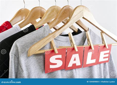 Sale In A Clothing Store Discount Sign At A Clothes Rack Stock Photo