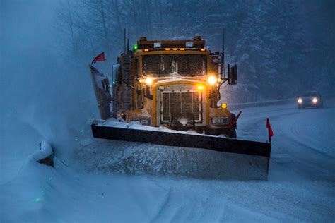Snowplow Plowing The Highway During Snow Storm Stock Photo Download