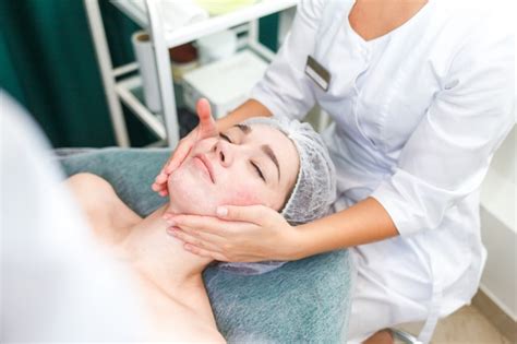 Premium Photo Doctor Beautician Makes Cosmetic Facial Massage Woman