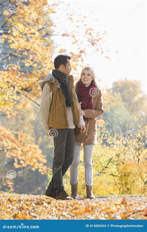 Full Length Of Couple Walking In Park During Autumn Stock Photo Image