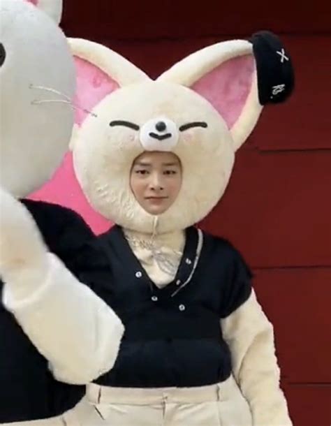 A Person In A Bunny Costume Standing Next To A Giant Stuffed Animal