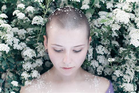 A Girl With A Shaved Head And Flowers By Erik Naumann