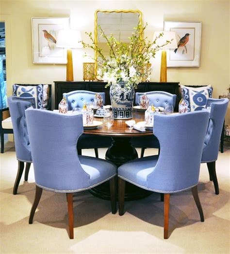 When classic dining room furnishings are a bit too traditional, turn to our collection of visually interesting and highly functional pieces. Stunning dining room vignette with upholstered blue dining chairs, round dining table, and blue ...