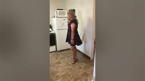 Crossdresser Paulette Wearing Black And Floral Dress Transvestite