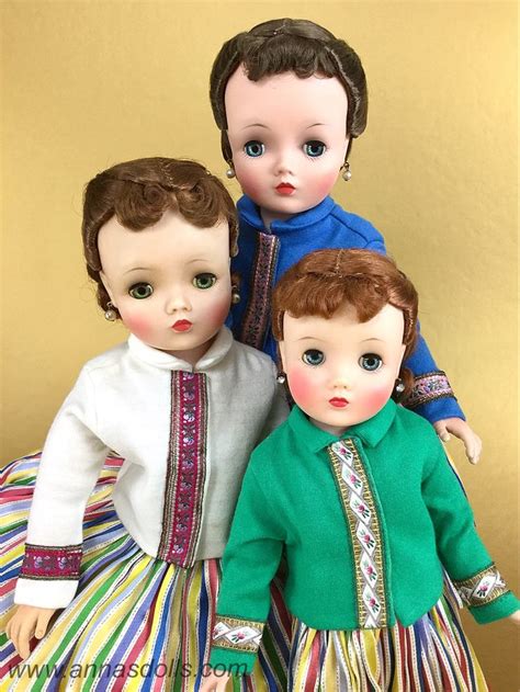Three Dolls Are Posed Next To Each Other