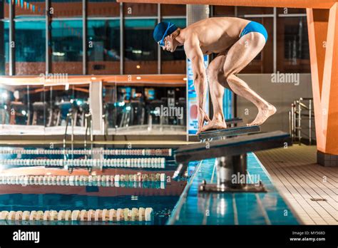 Swimmer Standing On Diving Board Ready To Jump Into Competition Swimming Pool Stock Photo Alamy