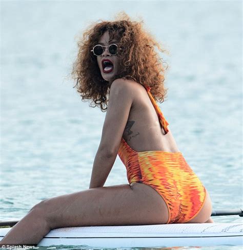 Rihanna Showcases Her Curves In A Flame Coloured Swimsuit As She Paddle