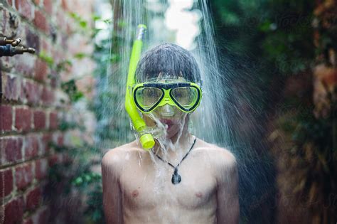 Boy In An Outdoor Shower Wearing A Snorkel Set Del Colaborador De