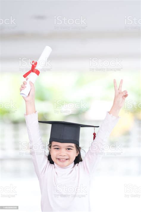Vertical Shot Of A Southeast Asian Schoolgirl With A Certificate