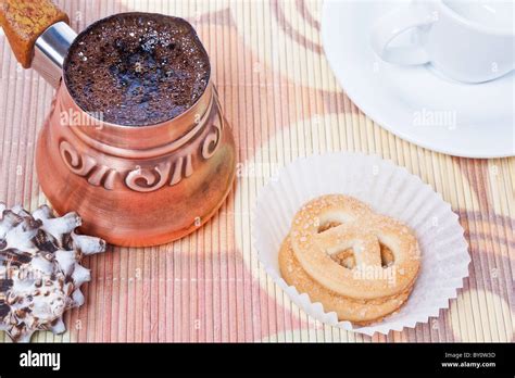 Freshly Brewed Hot Turkish Coffee In Copper Coffee Pot With Cup
