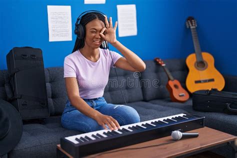 African American Woman With Braids Playing Piano Keyboard At Music