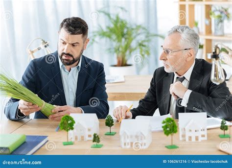 Serious Colleagues Looking At The Bunch Of Herbs And Thinking About It