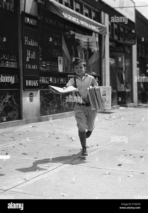 1930s Newspaper Boy In Knickers Walking Towards Camera On Street