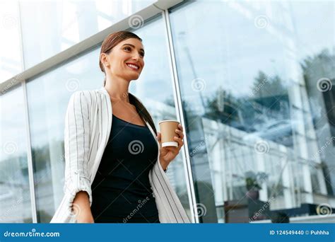 Beautiful Business Woman Going To Work Near Office Building Stock Photo