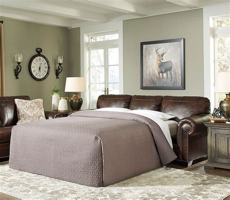 Play with patterns by layering an area rug or two on the floor, and keep an acrylic coffee table on top of it to let. Roleson Walnut Queen Sofa Sleeper Signature Design ...