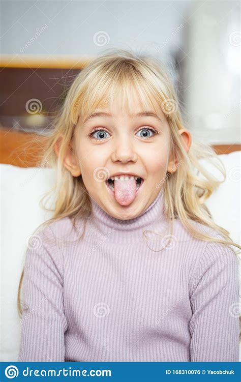 Cute Little Girl Sticking Out Her Tongue Stock Photo
