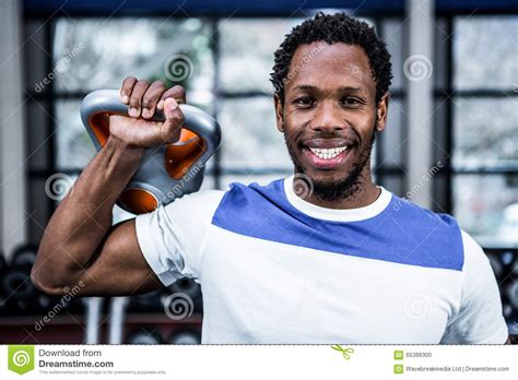 Smiling Muscular Man Lifting Kettlebells Stock Photo Image Of Fitness