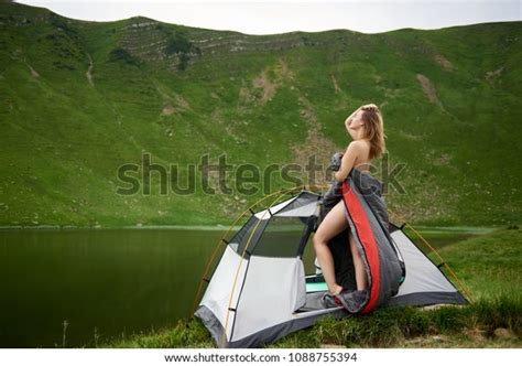 Side View Of Sporty Naked Woman Standing In Tent Entrance In Sleeping Bag Beautiful View Of