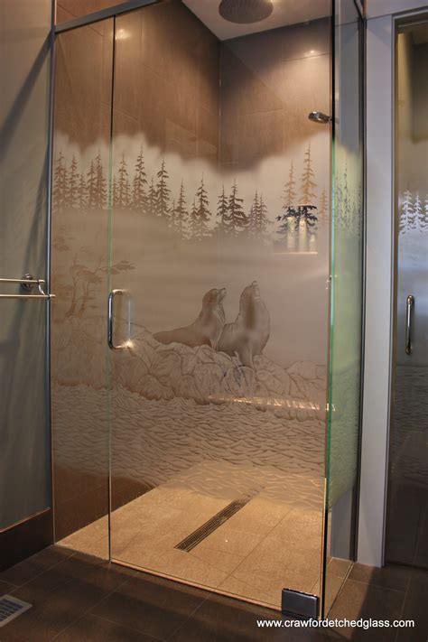 a bathroom with a glass shower door and mural on the wall