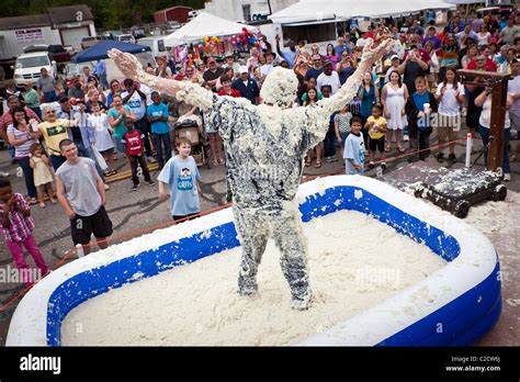 A Participant In The Grits Roll After Wallowing In A Pool Of Grits During The Annual World Grits