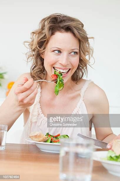 woman eating salad smiling photos and premium high res pictures getty images