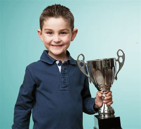 Happy Child Holding A Trophy Photo Free Download